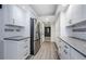 Bright kitchen features white cabinets, stainless steel refrigerator, and gray subway tile backsplash at 3021 Countryside Blvd # 45A, Clearwater, FL 33761