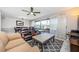 Living room featuring comfortable seating and a sliding glass door to the balcony at 3021 Countryside Blvd # 45A, Clearwater, FL 33761