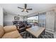 Open living room featuring sliding glass doors to the balcony, modern ceiling fan, and comfortable seating arrangement at 3021 Countryside Blvd # 45A, Clearwater, FL 33761
