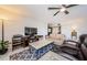 Open living room with entertainment center, comfortable sofa, recliners, and a ceiling fan at 3021 Countryside Blvd # 45A, Clearwater, FL 33761