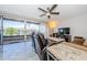 Living room with comfortable seating, a ceiling fan, a large TV, and sliding glass doors to the balcony at 3021 Countryside Blvd # 45A, Clearwater, FL 33761