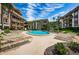 Condo community pool area, furnished with lounge chairs for sunbathing and relaxation at 3021 Countryside Blvd # 45A, Clearwater, FL 33761