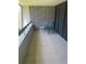 Cozy balcony with brick accent wall and neutral tile flooring and chair to enjoy the outdoors at 36750 Us 19 N # 4-205, Palm Harbor, FL 34684