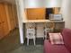 Charming breakfast bar with seating for two with mini fridge, sink, and microwave at 36750 Us 19 N # 4-205, Palm Harbor, FL 34684