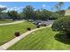 Lush landscaped grounds with a sidewalk leading to a parking lot and surrounding greenery at 36750 Us 19 N # 4-205, Palm Harbor, FL 34684