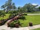 Beautifully landscaped grounds with manicured lawn, vibrant flowerbeds and elegant stairs at 36750 Us 19 N # 4-205, Palm Harbor, FL 34684