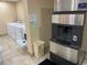 Onsite laundry room with multiple washer and dryer units and an ice machine at 36750 Us 19 N # 4-205, Palm Harbor, FL 34684