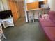 Cozy living room features plush sofa, breakfast bar, and TV with a view of the front door at 36750 Us 19 N # 4-205, Palm Harbor, FL 34684