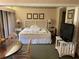 Bedroom featuring a plush bed, lamps, decorative artwork, and a TV at 36750 Us 19 N # 4-205, Palm Harbor, FL 34684