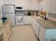Well-lit kitchen features white cabinetry, granite countertops, and stainless steel appliances at 3919 Harrisburg Ne St, St Petersburg, FL 33703