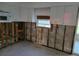 Kitchen framed out and ready for renovation with white cabinets and a microwave at 3919 Harrisburg Ne St, St Petersburg, FL 33703