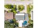 A bird's eye view of a home with a pool and outdoor seating nestled into a well-manicured landscape at 4106 W Cleveland St, Tampa, FL 33609