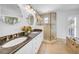 Bathroom featuring a double vanity, glass shower, and separate tub at 4106 W Cleveland St, Tampa, FL 33609