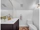 Elegant powder room with a modern sink, gold faucet, decorative mirror, and a white toilet at 4106 W Cleveland St, Tampa, FL 33609