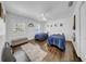 Bright bedroom features two twin beds, stylish decor, and gleaming hardwood floors at 4106 W Cleveland St, Tampa, FL 33609