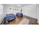 A bright bedroom is adorned with hardwood floors, two twin beds and charming decor at 4106 W Cleveland St, Tampa, FL 33609
