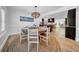 Open dining room features a wood table, decorative chandelier and coastal decor at 4106 W Cleveland St, Tampa, FL 33609