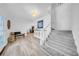 Bright foyer featuring stylish wood-look flooring, elegant staircase, and decorative elements at 4106 W Cleveland St, Tampa, FL 33609