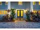 Charming front door, complemented by tasteful landscaping and warm exterior lighting for an inviting entrance at 4106 W Cleveland St, Tampa, FL 33609