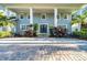 Inviting front facade with prominent columns and a brick paver walkway leading to a charming entrance at 4106 W Cleveland St, Tampa, FL 33609