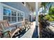 Cozy porch area featuring comfortable rocking chairs and attractive landscaping for a relaxing outdoor experience at 4106 W Cleveland St, Tampa, FL 33609