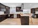 Modern kitchen with dark wood cabinets, stainless appliances, and island seating at 4106 W Cleveland St, Tampa, FL 33609