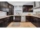Stylish kitchen featuring stainless steel appliances and dark wood cabinets at 4106 W Cleveland St, Tampa, FL 33609