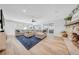 Sunlit living room featuring neutral decor, a stone fireplace, hardwood floors, and sliding glass doors at 4106 W Cleveland St, Tampa, FL 33609