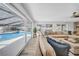 Bright living area with views of the pool, a stone fireplace, hardwood floors, and comfortable seating at 4106 W Cleveland St, Tampa, FL 33609