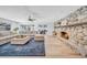 Inviting living room with a stone fireplace, comfortable sofa and seamless access to the outdoor area at 4106 W Cleveland St, Tampa, FL 33609