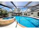 Backyard oasis featuring a screened-in pool and spa with a lounging area at 4106 W Cleveland St, Tampa, FL 33609