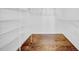 Walk-in closet with custom shelving and hardwood floors at 4106 W Cleveland St, Tampa, FL 33609