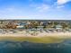 Aerial view showing the community beach and many waterfront homes at 4210 Headsail Dr, New Port Richey, FL 34652