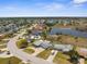 An aerial view of a residential area featuring houses with canals and lake views at 4210 Headsail Dr, New Port Richey, FL 34652