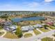 This aerial view highlights a community featuring homes surrounding a scenic lake and access to water activities at 4210 Headsail Dr, New Port Richey, FL 34652