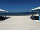 Community beach with shade structures and picnic areas for outdoor relaxation by the water at 4210 Headsail Dr, New Port Richey, FL 34652