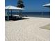 Community beach with shade structures and picnic areas for outdoor relaxation by the water at 4210 Headsail Dr, New Port Richey, FL 34652
