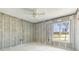 Exposed cinder block walls and the ceiling fan in bedroom await finishing touches at 4210 Headsail Dr, New Port Richey, FL 34652