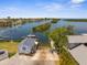 An aerial view features a well-maintained boat ramp providing direct access to the open waterway at 4210 Headsail Dr, New Port Richey, FL 34652