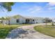 Charming single-story home features a circular driveway, attached garage, and well-manicured lawn at 4210 Headsail Dr, New Port Richey, FL 34652