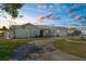 Charming single-story home features a circular driveway, attached garage, and well-manicured lawn at 4210 Headsail Dr, New Port Richey, FL 34652