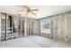 Partially renovated garage space with block walls, window, and ceiling fan in a home awaiting completion at 4210 Headsail Dr, New Port Richey, FL 34652