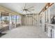 Sunroom boasts sliding glass doors, ceiling fan, and exposed framing details at 4210 Headsail Dr, New Port Richey, FL 34652