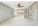 Interior features exposed block walls and ceiling fan during renovation, bright window at 4210 Headsail Dr, New Port Richey, FL 34652