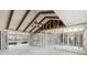 Spacious living room under renovation with exposed framing, vaulted ceiling with beams, and ceiling fan at 4210 Headsail Dr, New Port Richey, FL 34652