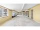 Bright living room with exposed block walls and a ceiling fan during renovation at 4210 Headsail Dr, New Port Richey, FL 34652