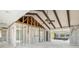 Spacious living room under renovation with exposed framing, vaulted ceiling with beams, and ceiling fan at 4210 Headsail Dr, New Port Richey, FL 34652