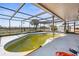 Enclosed pool area showing the in-ground pool requiring maintenance and scenic views at 4210 Headsail Dr, New Port Richey, FL 34652