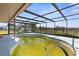 A screened-in pool area for private outdoor relaxation, though the pool is overdue for cleaning and maintenance at 4210 Headsail Dr, New Port Richey, FL 34652