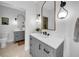 Bathroom featuring dual vanities, decorative mirrors, and designer tile floors at 422 Islebay Dr, Apollo Beach, FL 33572